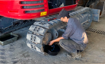 Technician working on excavator