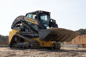 A New Holland track loader carrying a full bucket