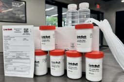 Fluid analysis sample bottles and a Link-Belt form on a counter