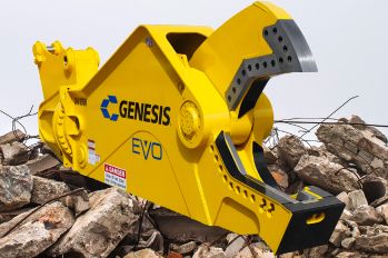 A yellow Genesis shear on a pile of broken concrete