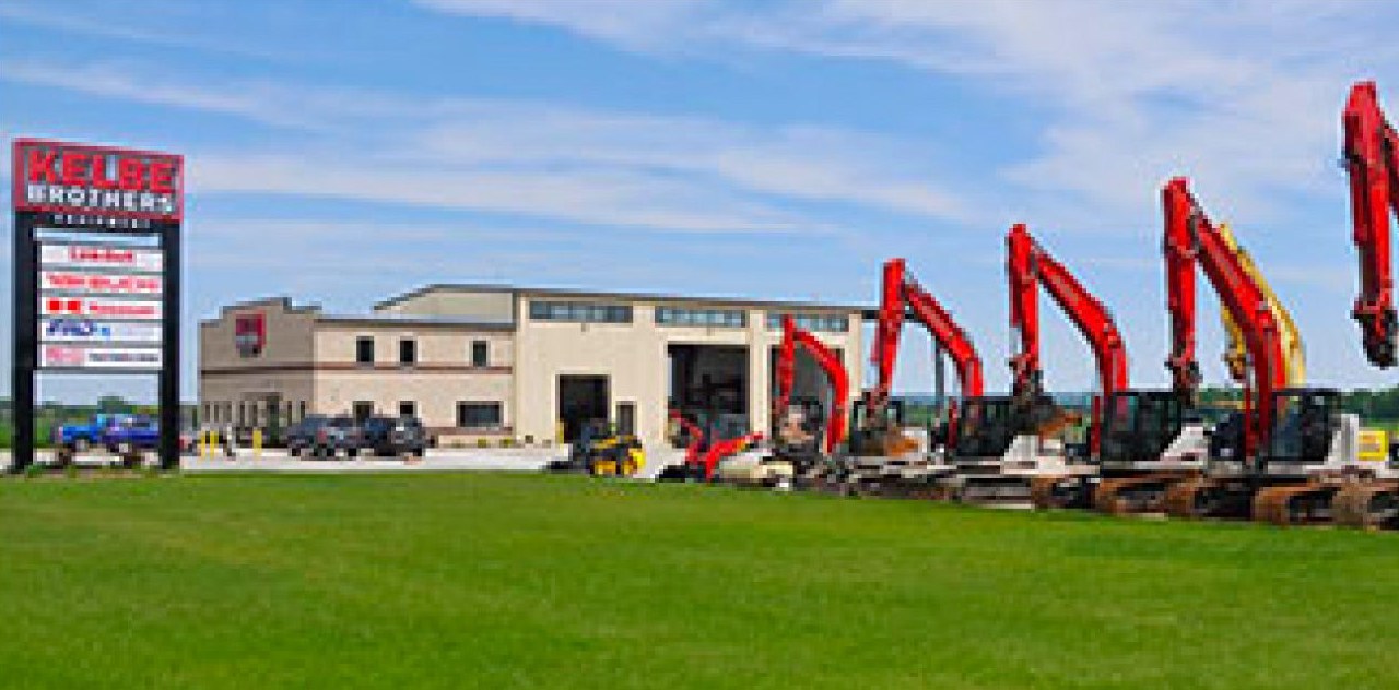 Excavators lined up in front of Kelbe Brothers Equipment on French Road in De Pere