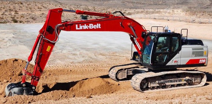 A Link-Belt excavator digging on a dirt site