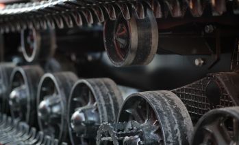 Rows of track rollers and steel track chain